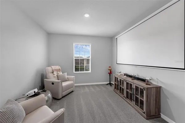a living room with furniture stairs and a window