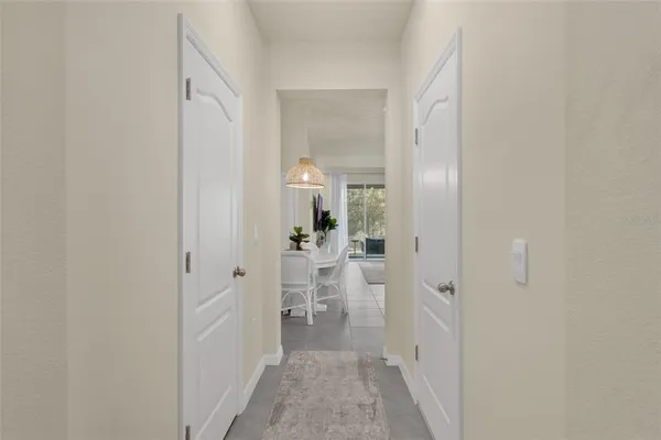 a view of a hallway with a livingroom and furniture