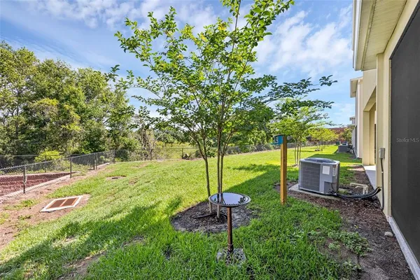 a backyard of a house with table and chairs