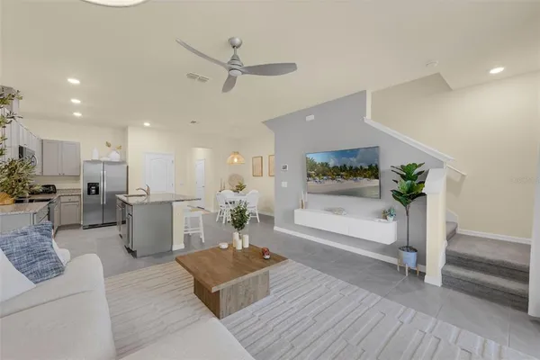 a living room with furniture and a potted plant