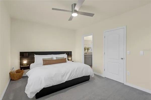 a bedroom with a bed and ceiling fan