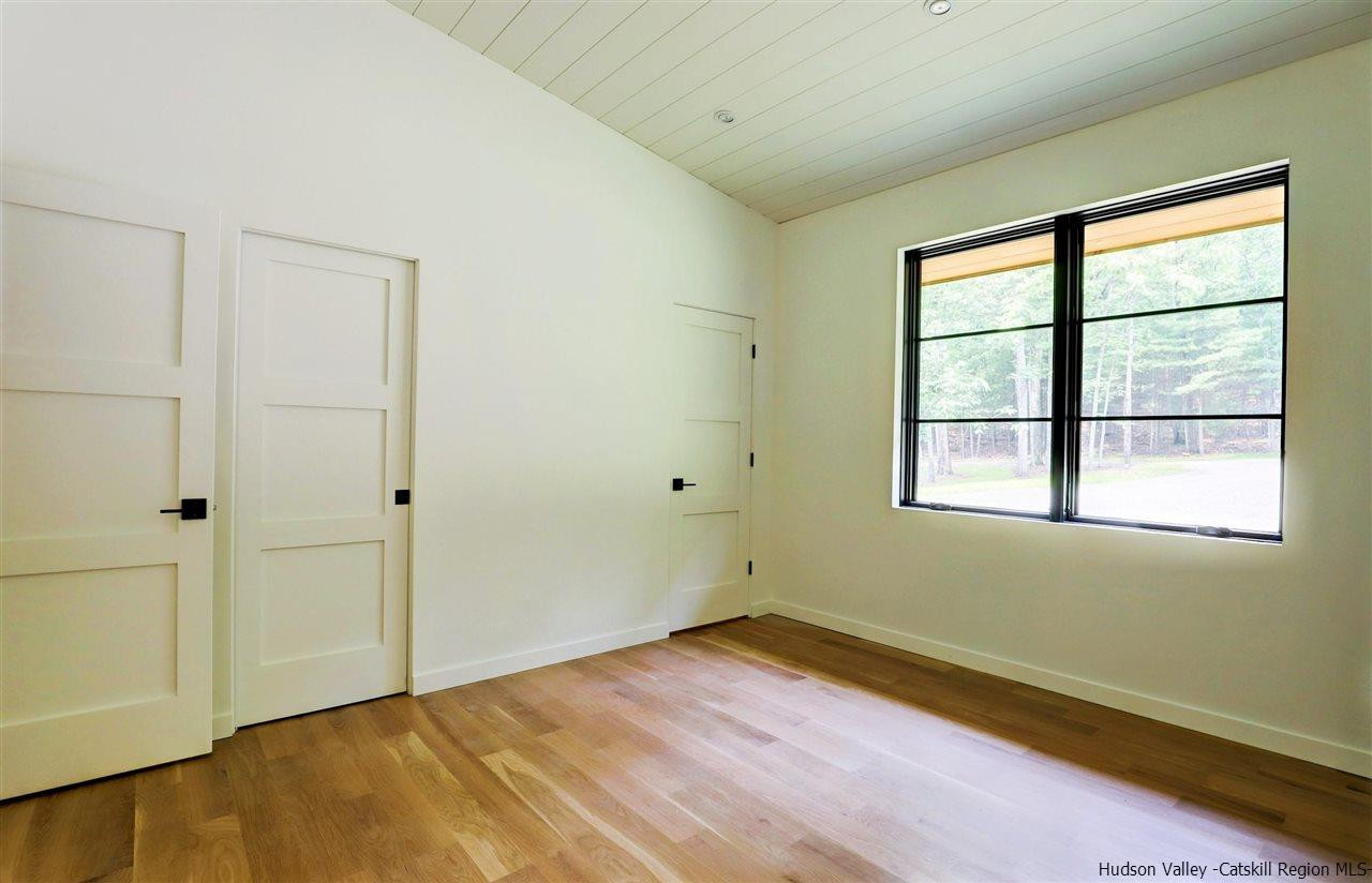 10 Hidden Mountain Stone Ridge, NY 12484 - Photo 18 of 35 a view of empty room with wooden floor and fan