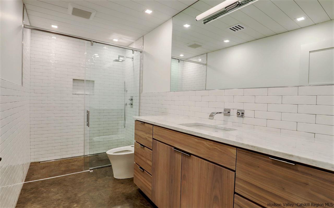 10 Hidden Mountain Stone Ridge, NY 12484 - Photo 23 of 35 a bathroom with a sink a toilet a mirror and shower