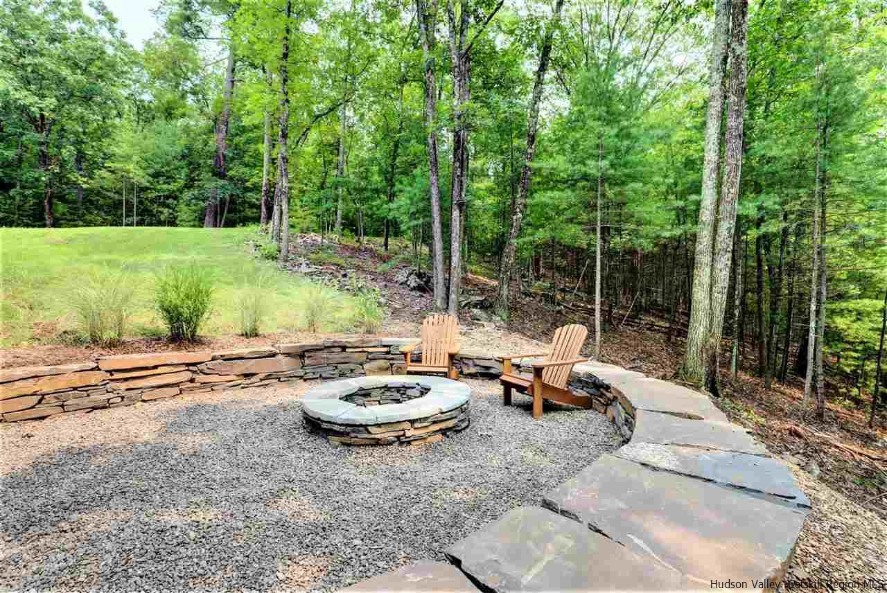 10 Hidden Mountain Stone Ridge, NY 12484 - Photo 29 of 35 a view of a patio with lawn chairs and couches with wooden floor and fence