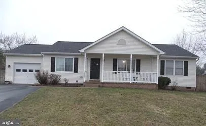 a front view of a house with a garden and porch
