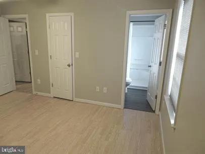an empty room with closet and mirror