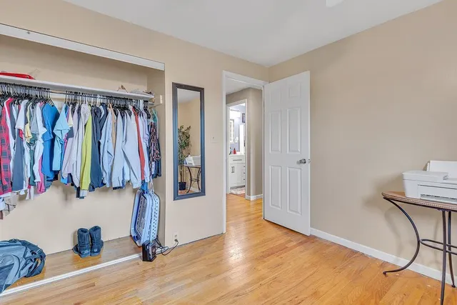 a view of walk in closet with clothes and shoes