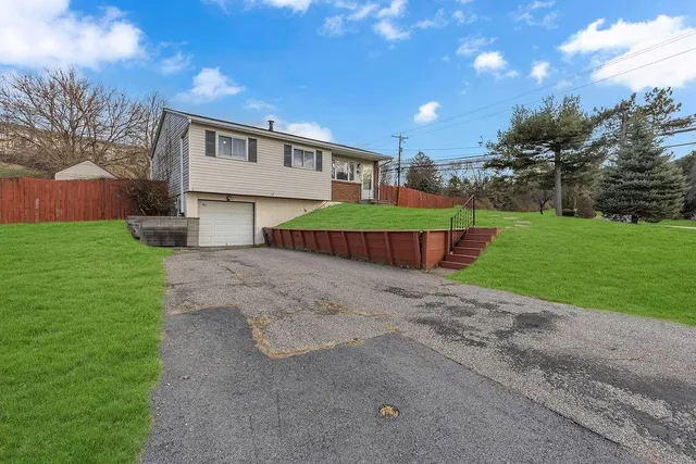 a front view of a house with a garden and yard