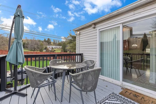 a view of a chairs and table in the balcony