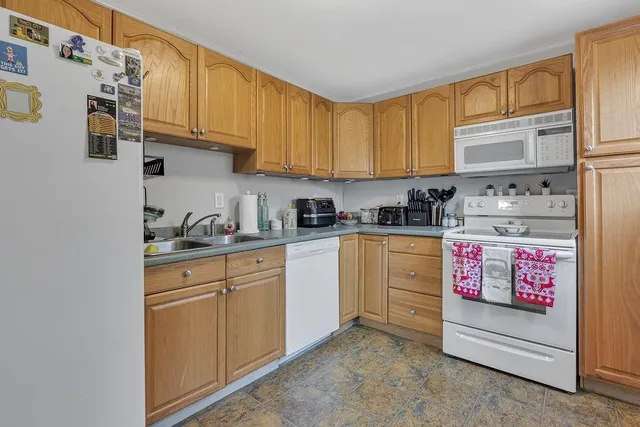 a kitchen with granite countertop cabinets and appliances