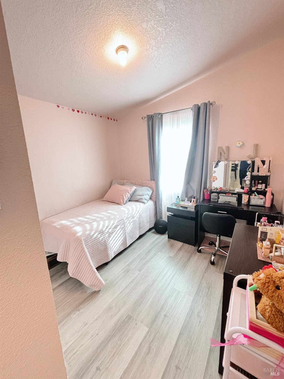 3309 South Santa Rosa Avenue South, Unit 16 Santa Rosa, CA 95407 - Photo 13 of 16 a bedroom with a bed and wooden floor