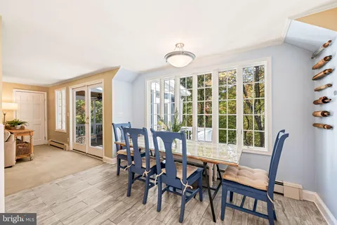 a dining room with furniture and a large window