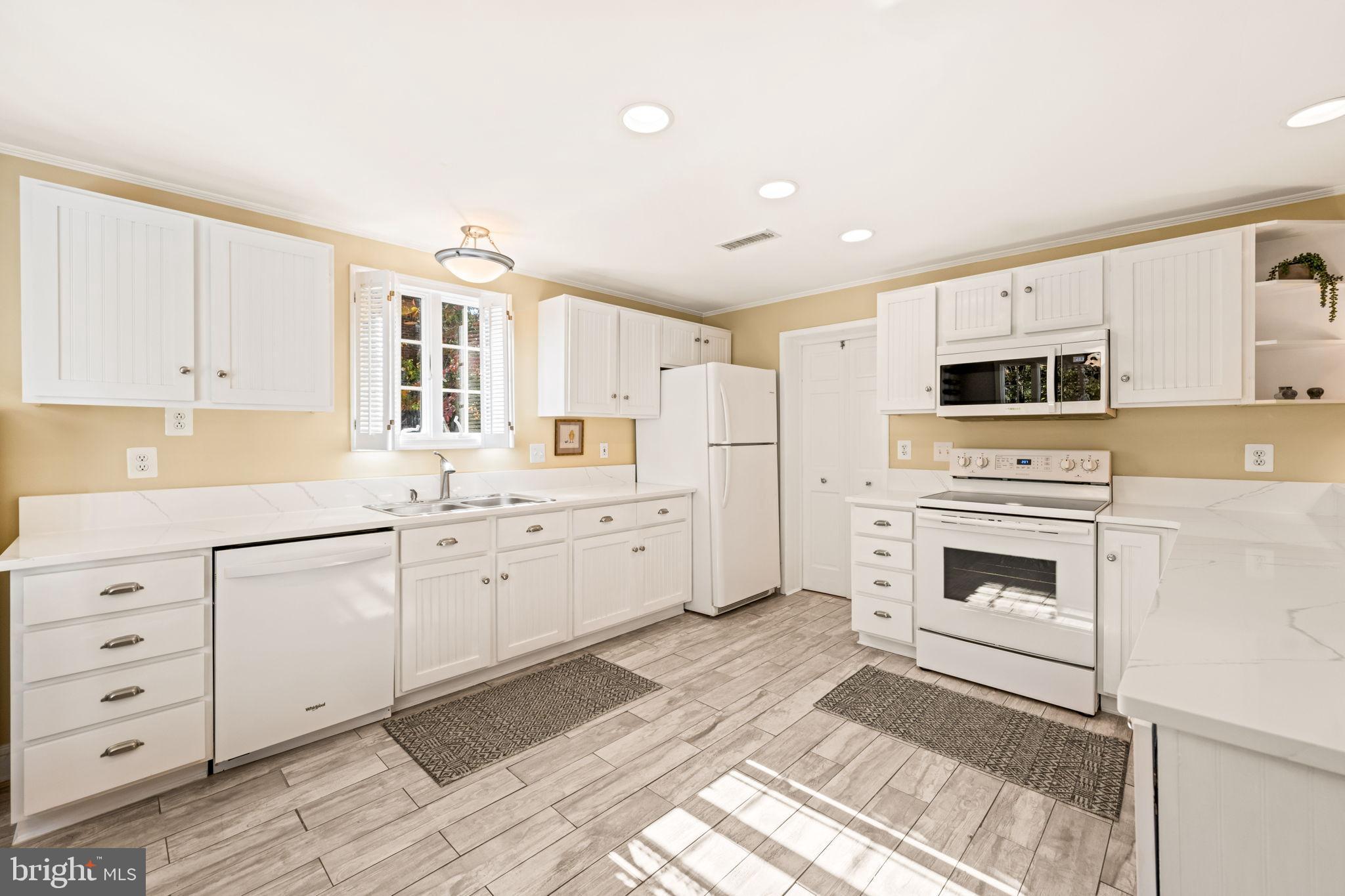 3203 Circle Hill Road Alexandria, VA 22305 - Photo 15 of 48 a kitchen with granite countertop white cabinets and stainless steel appliances