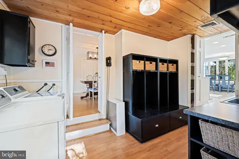 a kitchen with kitchen island granite countertop a sink appliances cabinets and furniture