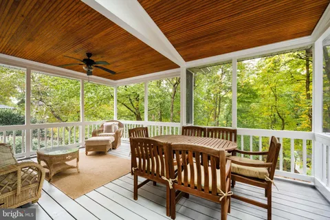 a view of a chairs and table in patio with a small yard