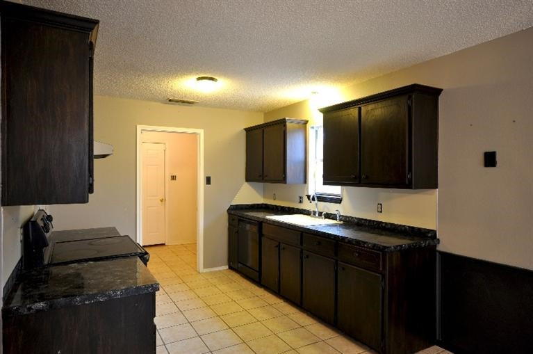 1003 Juneau Avenue Lubbock, TX 79416 - Photo 7 of 10 Kitchen with wood stained cabinets