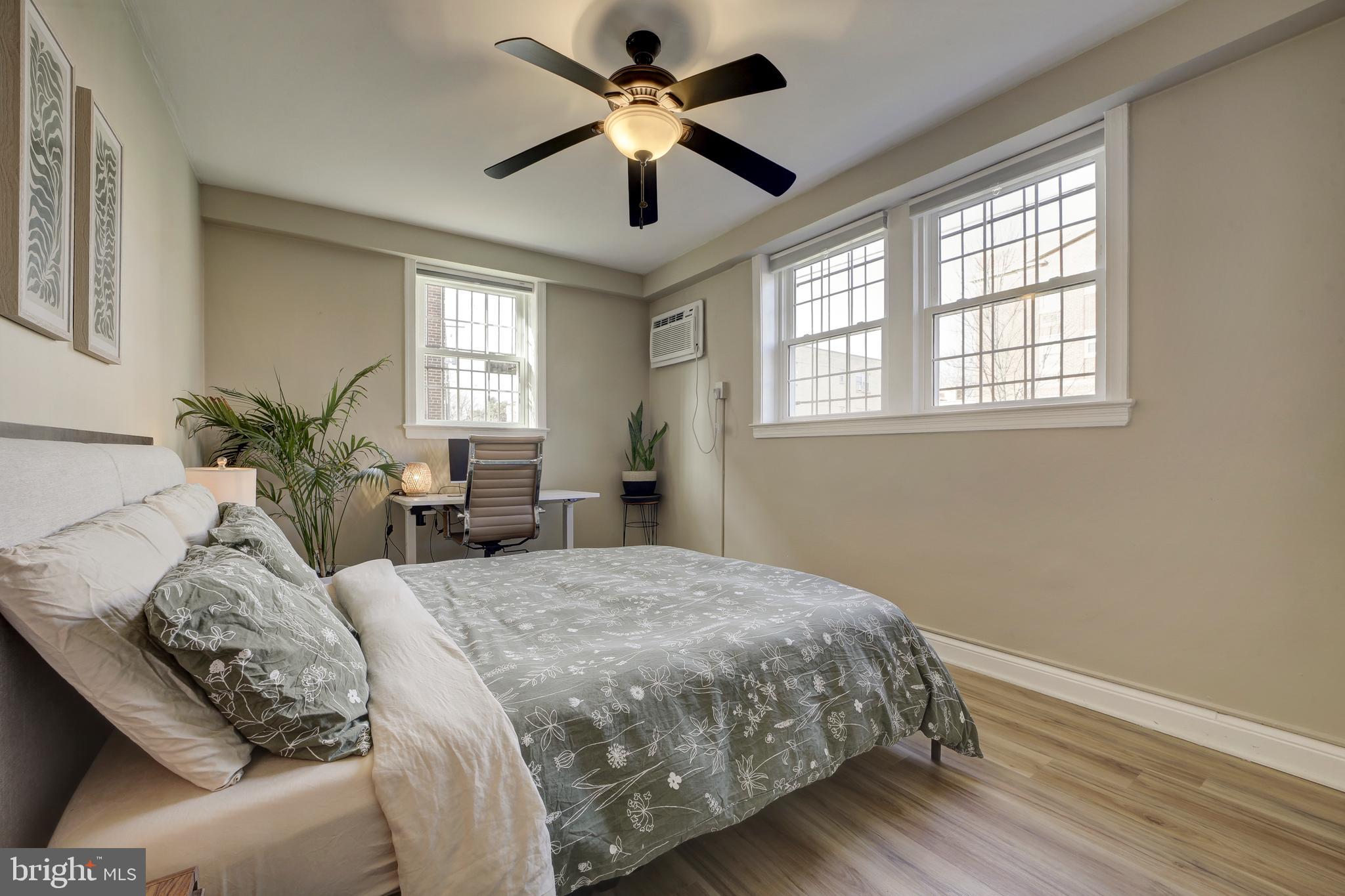 1404 Tuckerman Street Northwest, Unit 1 Washington, DC 20011 - Photo 11 of 18 a bedroom with a large bed chandelier and a window