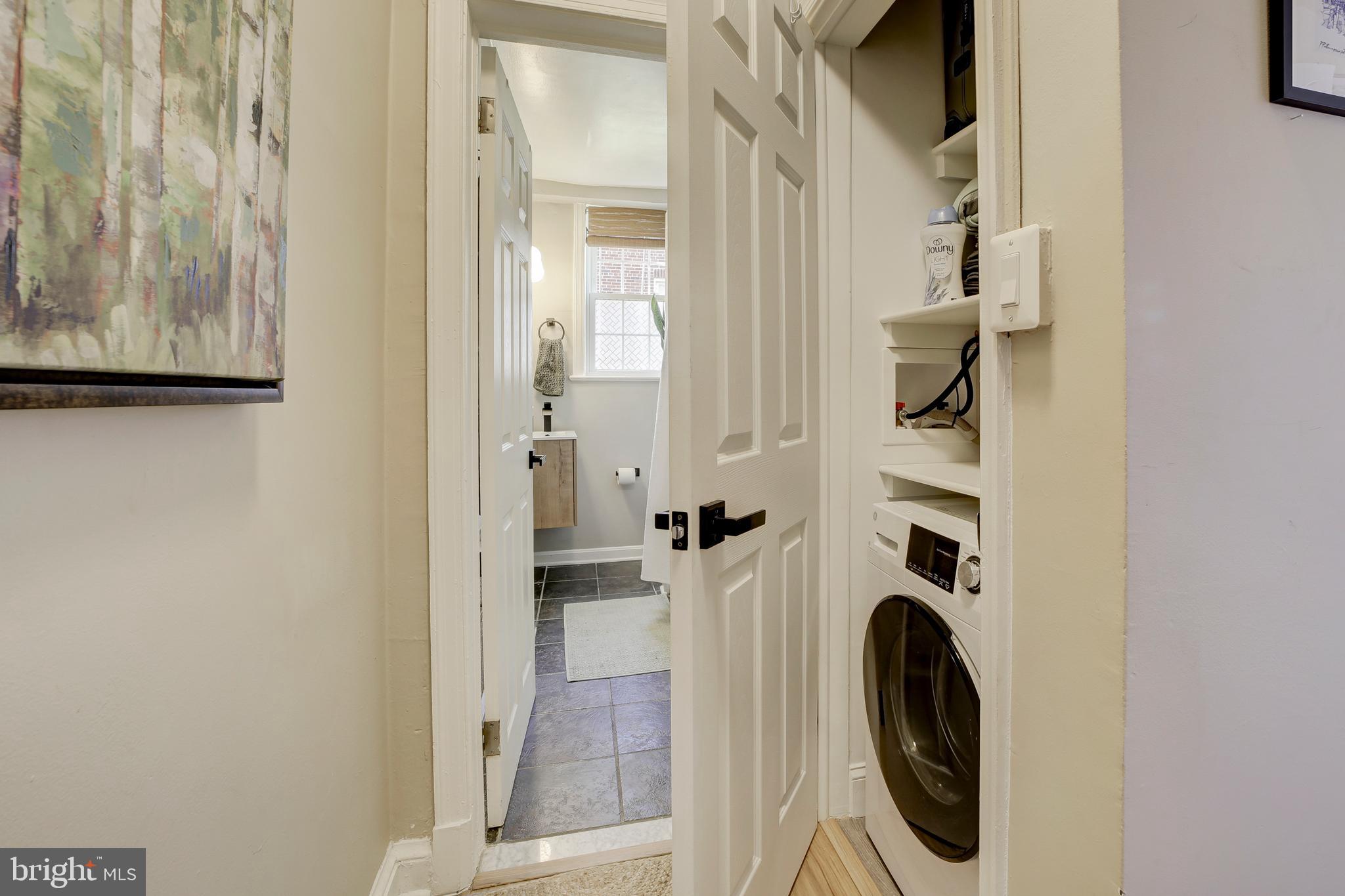 1404 Tuckerman Street Northwest, Unit 1 Washington, DC 20011 - Photo 14 of 18 a view of a hallway with washer and dryer
