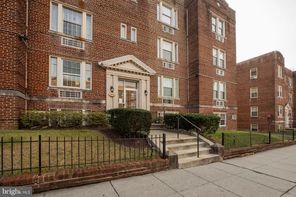 a view of a brick building and floor to ceiling windows