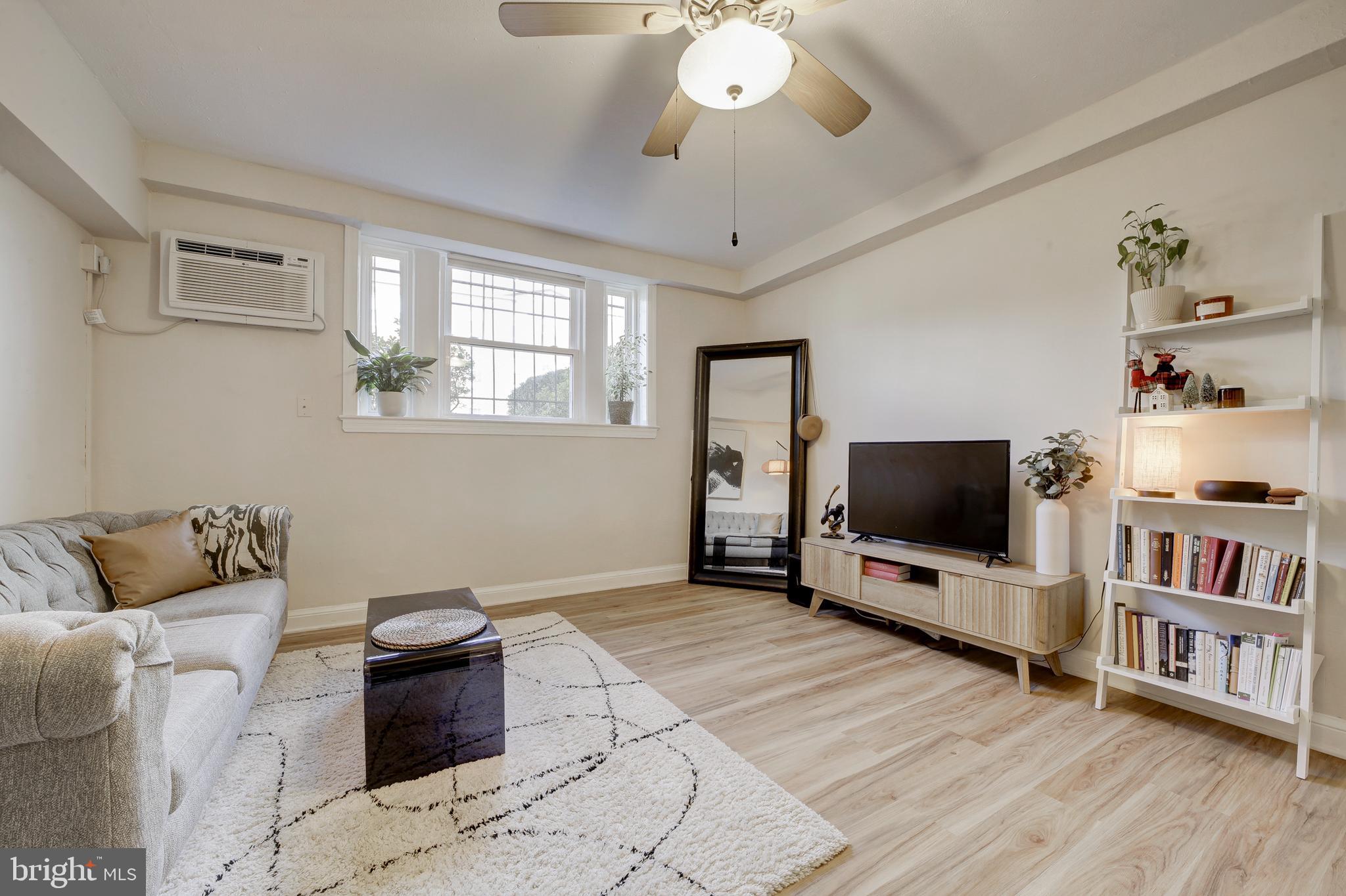 1404 Tuckerman Street Northwest, Unit 1 Washington, DC 20011 - Photo 4 of 18 a living room with furniture and a flat screen tv