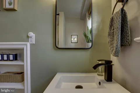 a bathroom with a sink and mirror