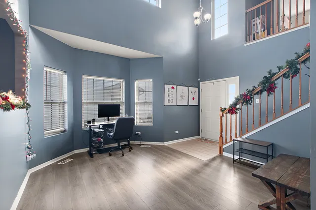 a workspace with wooden floor and windows