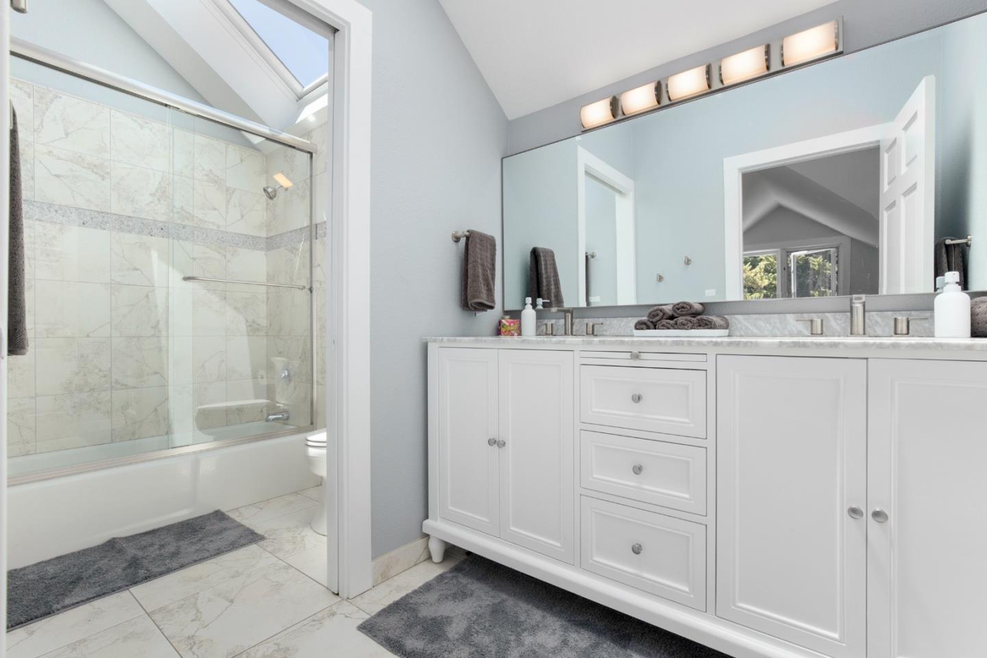 772 Aptos Ridge Circle Watsonville, CA 95076 - Photo 51 of 62 a bathroom with a double vanity sink a mirror and a bathtub