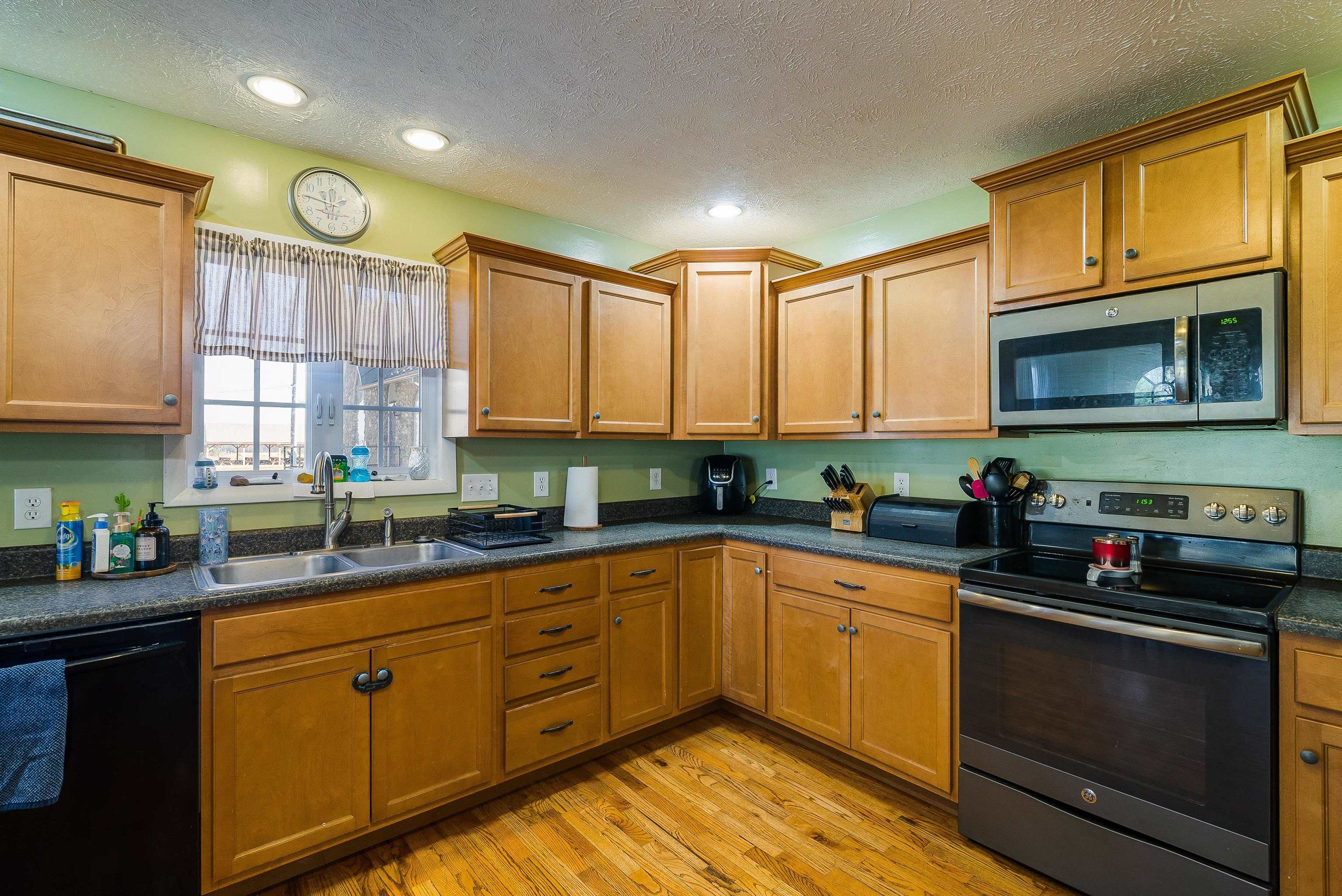 7110 Rocky Bar Road Elkton, VA 22827 - Photo 13 of 52 a kitchen with stainless steel appliances granite countertop a stove a sink dishwasher and a microwave