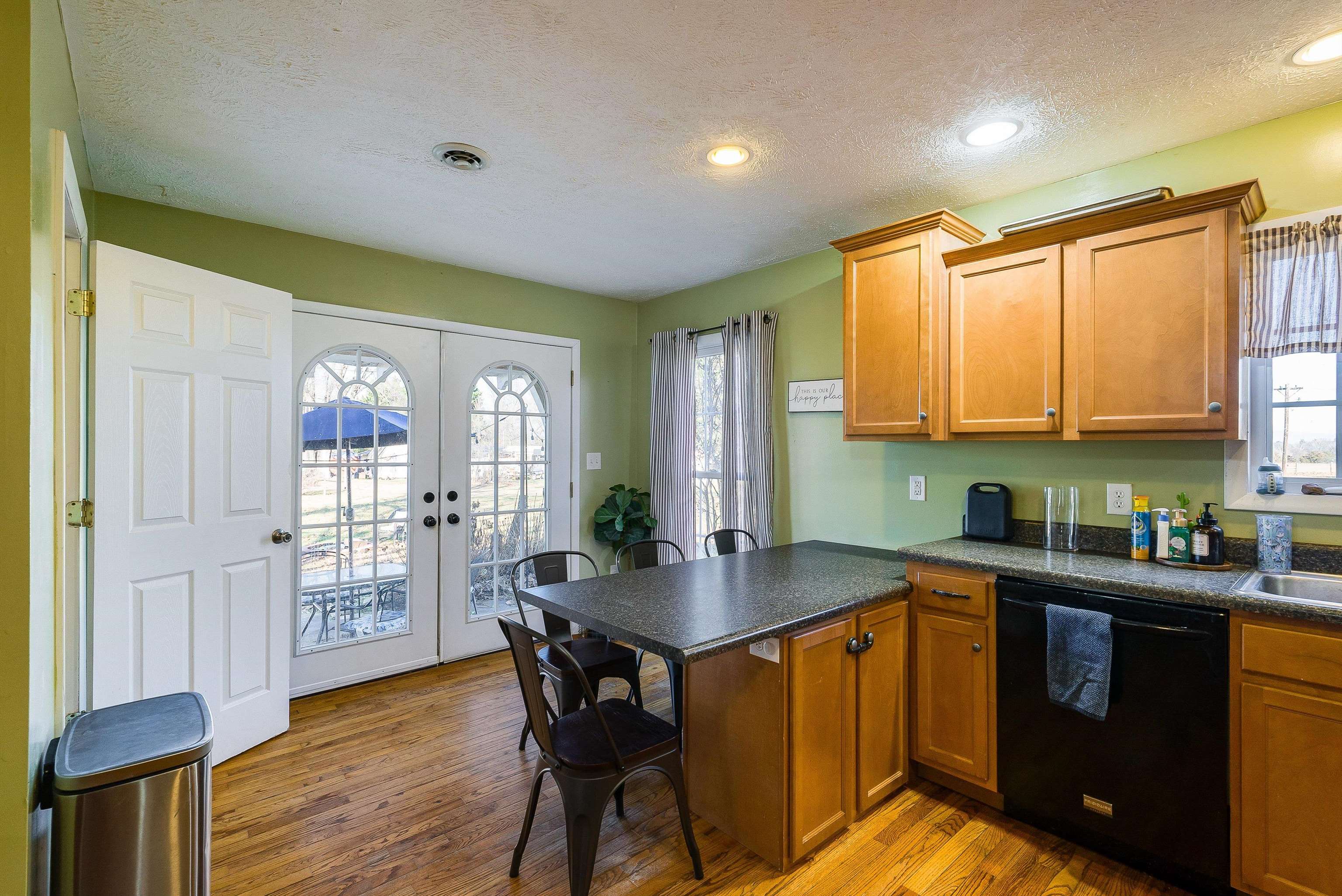 7110 Rocky Bar Road Elkton, VA 22827 - Photo 14 of 52 a kitchen with stainless steel appliances granite countertop wooden cabinets a stove top oven a sink and dishwasher with wooden floor
