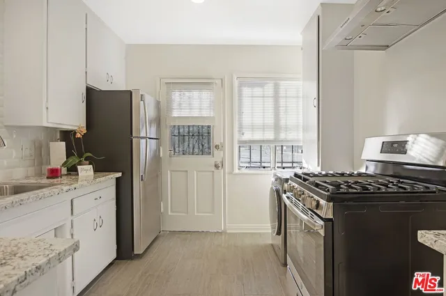 a kitchen that has a cabinets and a stove top oven