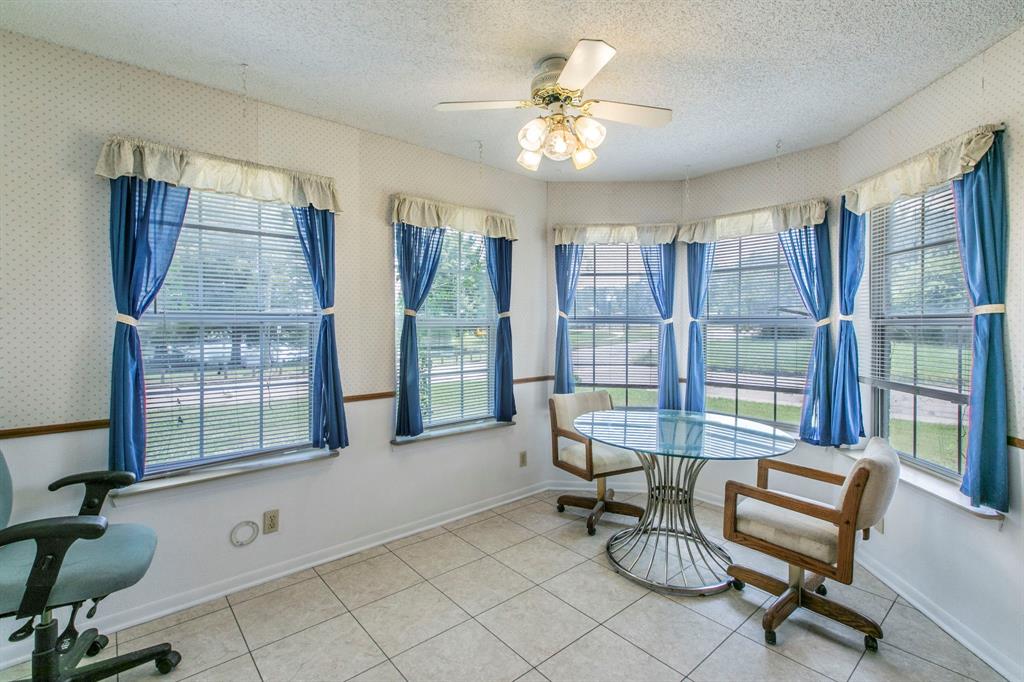 1936 Post Oak Drive Waco, TX 76705 - Photo 9 of 33 Sunroom featuring tile patterned flooring, a textured ceiling, and wallpapered walls