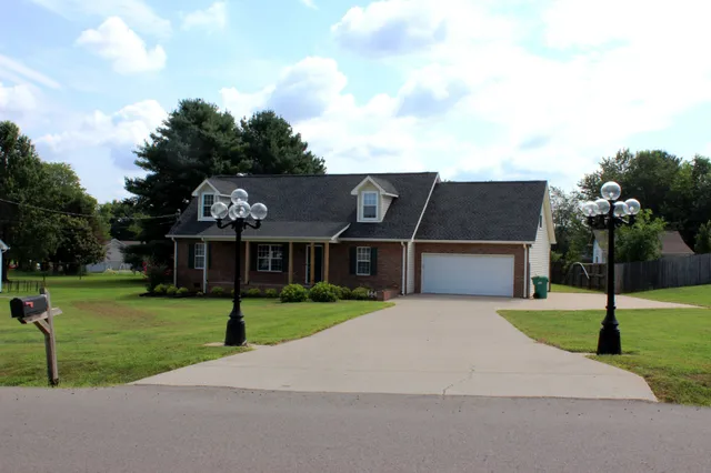 a front view of house with yard and green space
