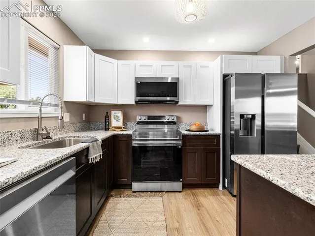 a kitchen with a sink stove and refrigerator