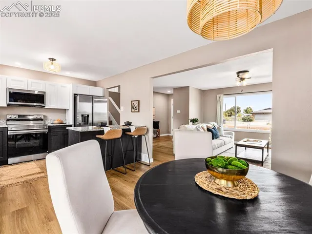 a living room with furniture and a dining table