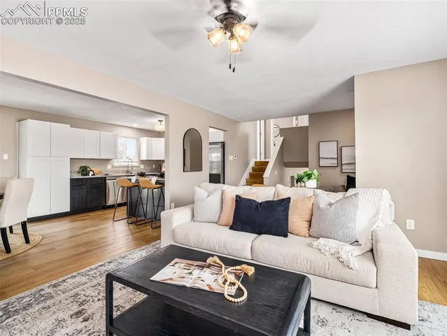 a living room with furniture and kitchen view