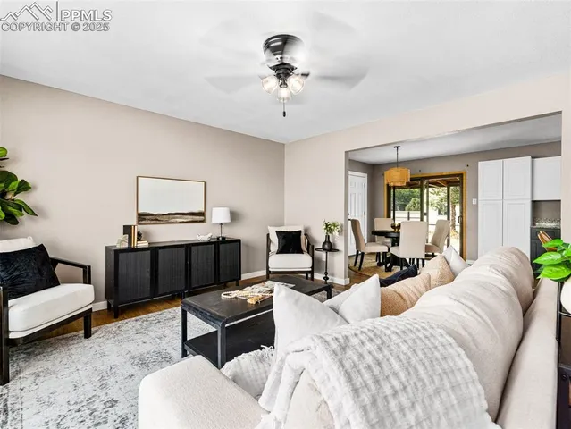 a living room with furniture a rug and a chandelier