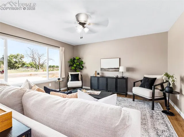 a living room with furniture and a large window