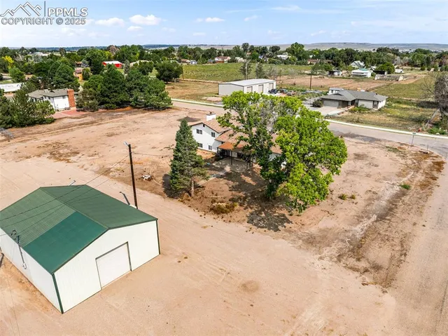 a view of a house with a snow on the road