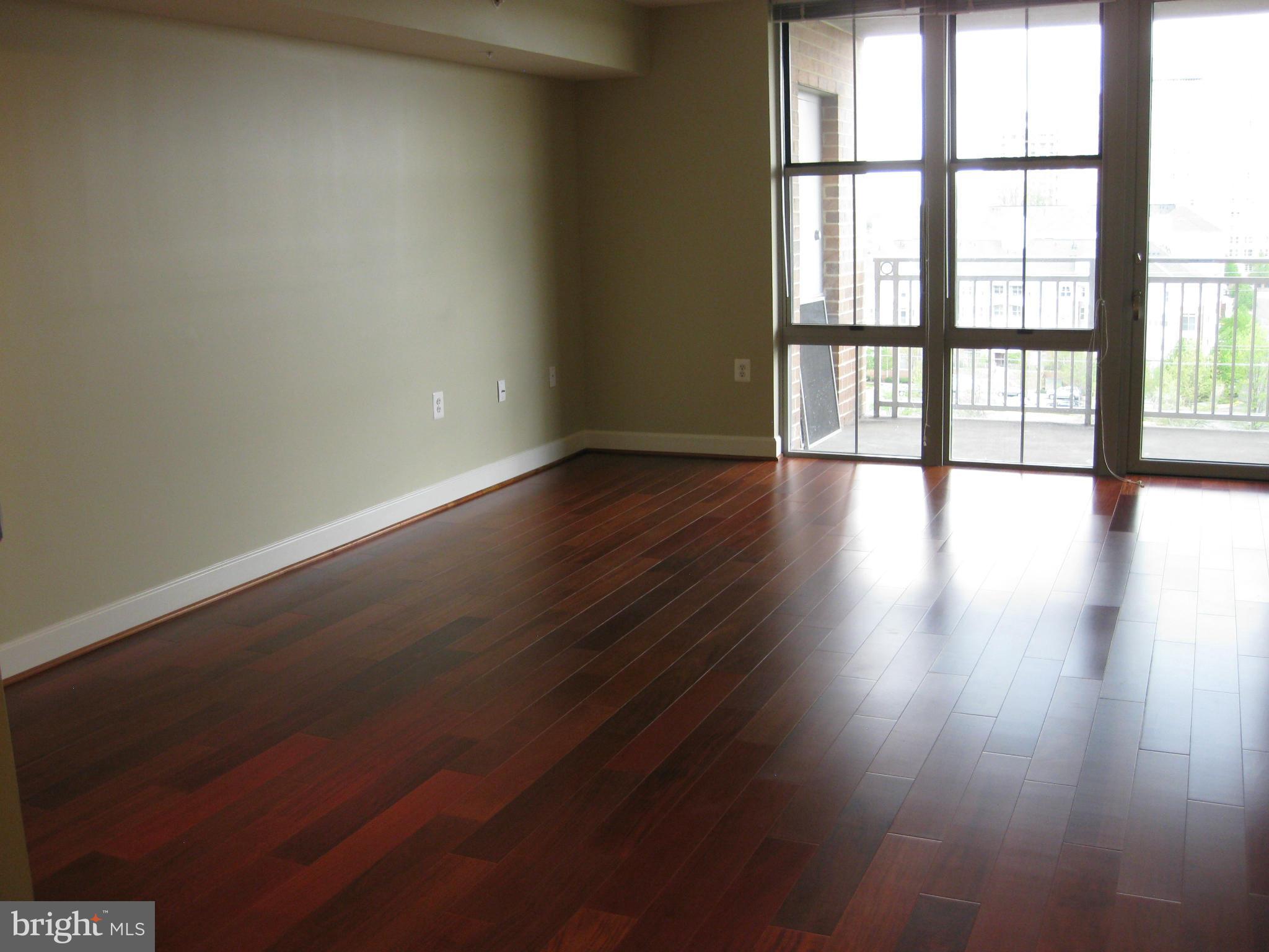 11800 Sunset Hills Road, Unit 925 Reston, VA 20190 - Photo 12 of 29 a view of an empty room with wooden floor and a window