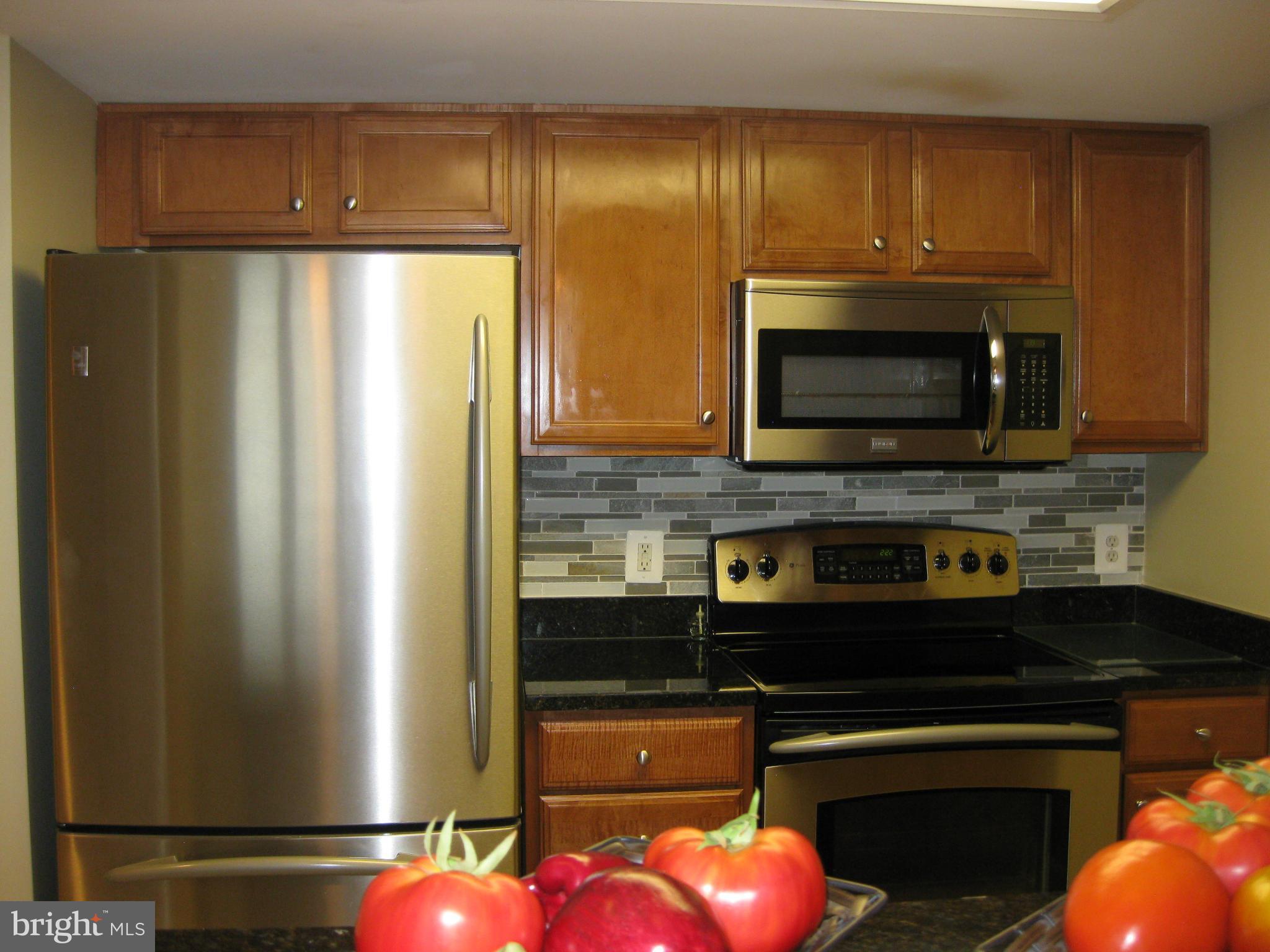11800 Sunset Hills Road, Unit 925 Reston, VA 20190 - Photo 14 of 29 a kitchen with a refrigerator stove and microwave