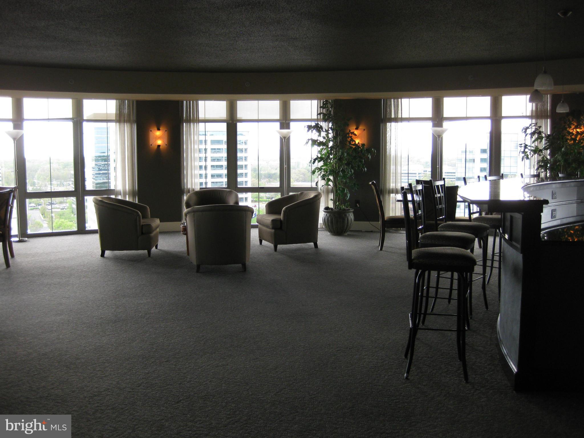 11800 Sunset Hills Road, Unit 925 Reston, VA 20190 - Photo 23 of 29 a living room with furniture and a floor to ceiling window