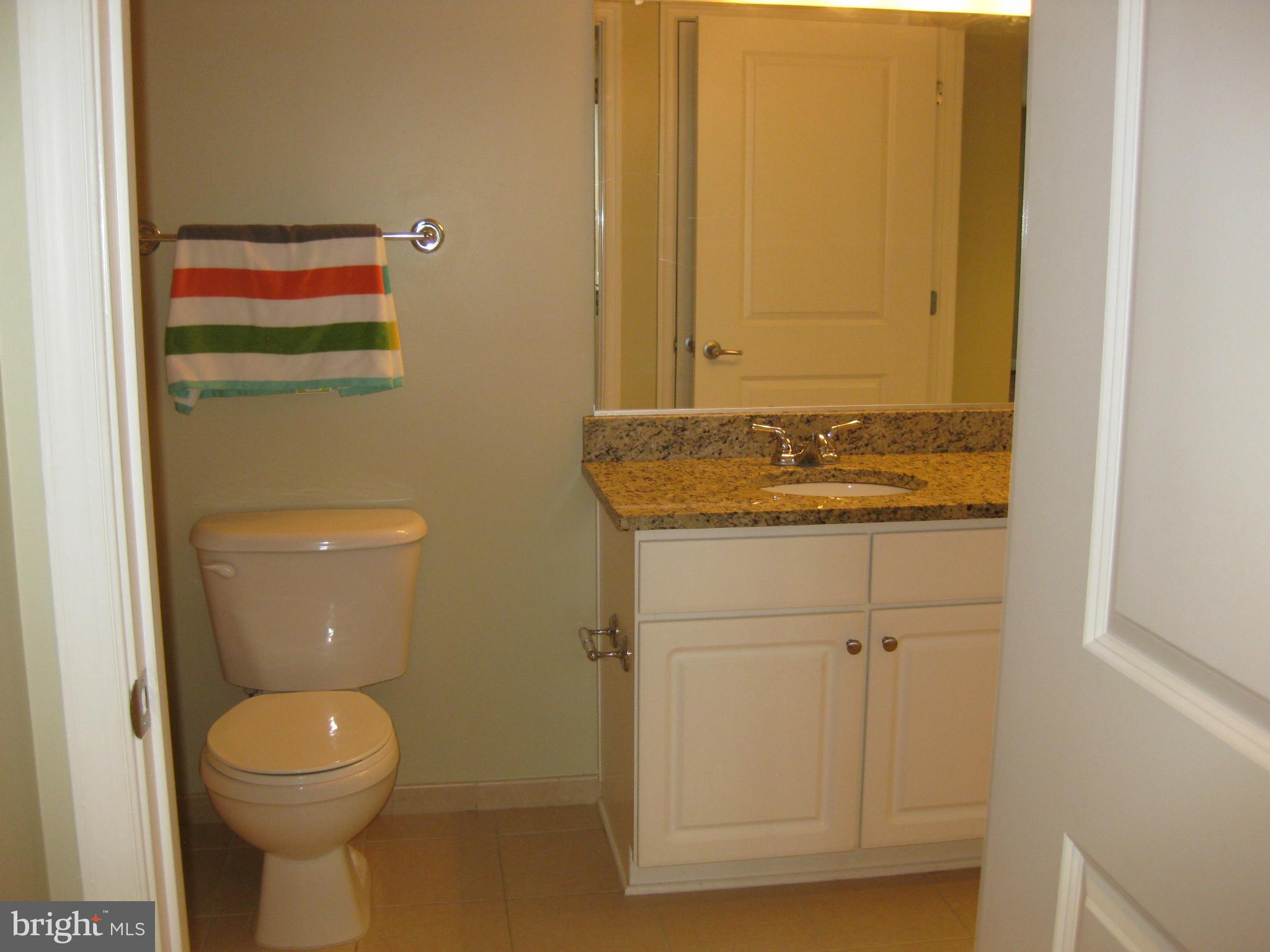 11800 Sunset Hills Road, Unit 925 Reston, VA 20190 - Photo 6 of 29 a bathroom with a toilet a sink and mirror