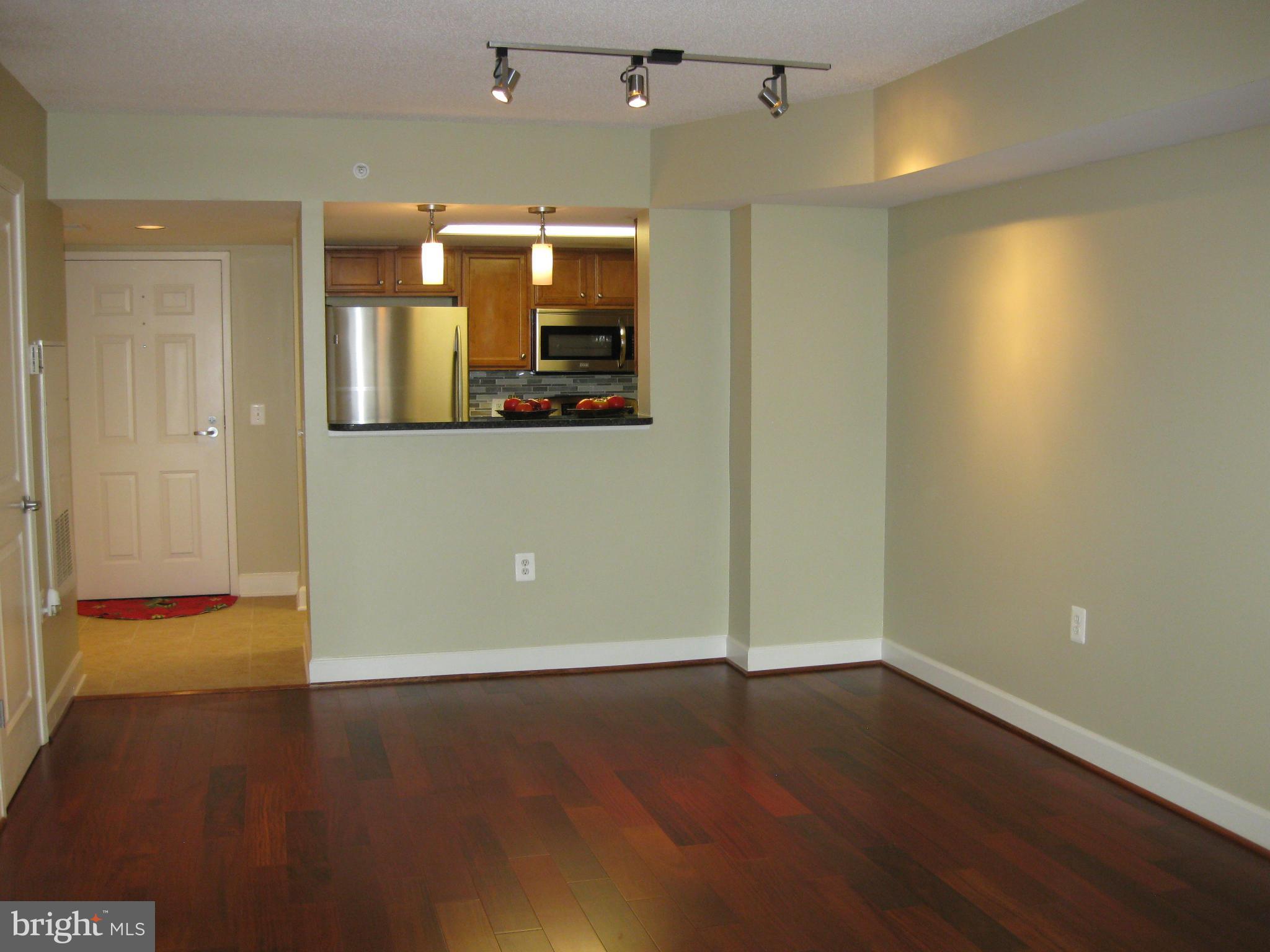 11800 Sunset Hills Road, Unit 925 Reston, VA 20190 - Photo 10 of 29 an empty room with wooden floor and mirror