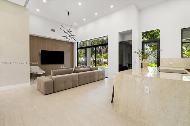 a large kitchen with a large window and stainless steel appliances