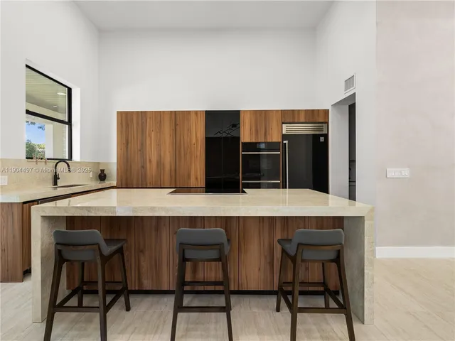 a kitchen with stainless steel appliances a refrigerator and a stove top oven