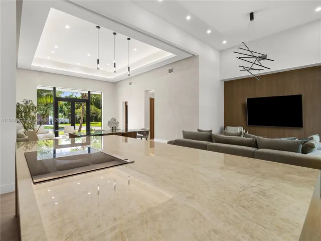 a dining room with furniture a chandelier and a rug