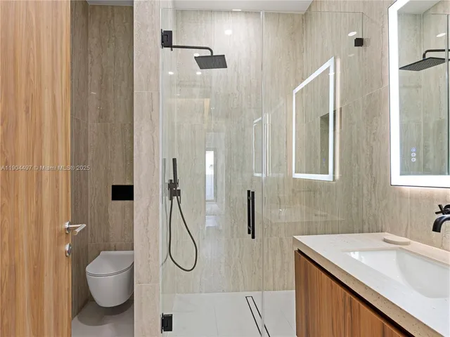 a large bathroom with a double vanity sink a large mirror and a bathtub