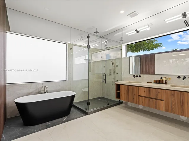 a bathroom with a bathtub and shower