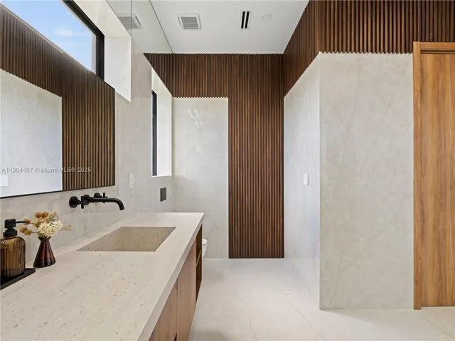 a bathroom with a sink a mirror and a bathtub