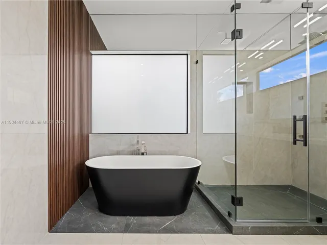a bathroom with a sink a mirror and shower